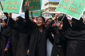 Indian Muslim women shout anti-Pakistani slogans prior to an effigy of Pakistani Prime Minister, Nawaz Sheriff being set alight during a protest in Ahmedabad on September 21, 2016.  Protests across India have flared up after a terrorist attack on an Indian Army Camp by allegedly Pakistani trained and supported terrorists in India-administered Kashmir's Uri sector.  / AFP PHOTO / SAM PANTHAKY